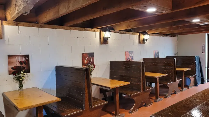 Wooden booth seating with lantern sconces in the restored 1960s speakeasy tasting room